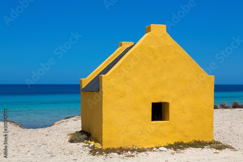 One yellow slave house at beach of Bonaire photo