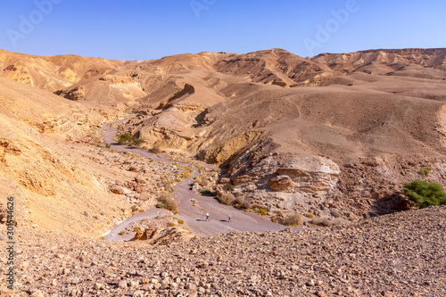 View of the colorful mountains and valley of Eilat Red Canyon against the blue sky. Israel