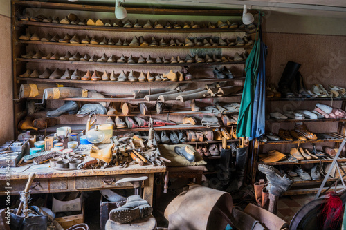  View into a shoemakers workshop with many old shoes and toolsSchwaebisch Hall, Wackershofen, Germany - 15 October 2019: View into a shoemakers workshop with many old shoes and tools