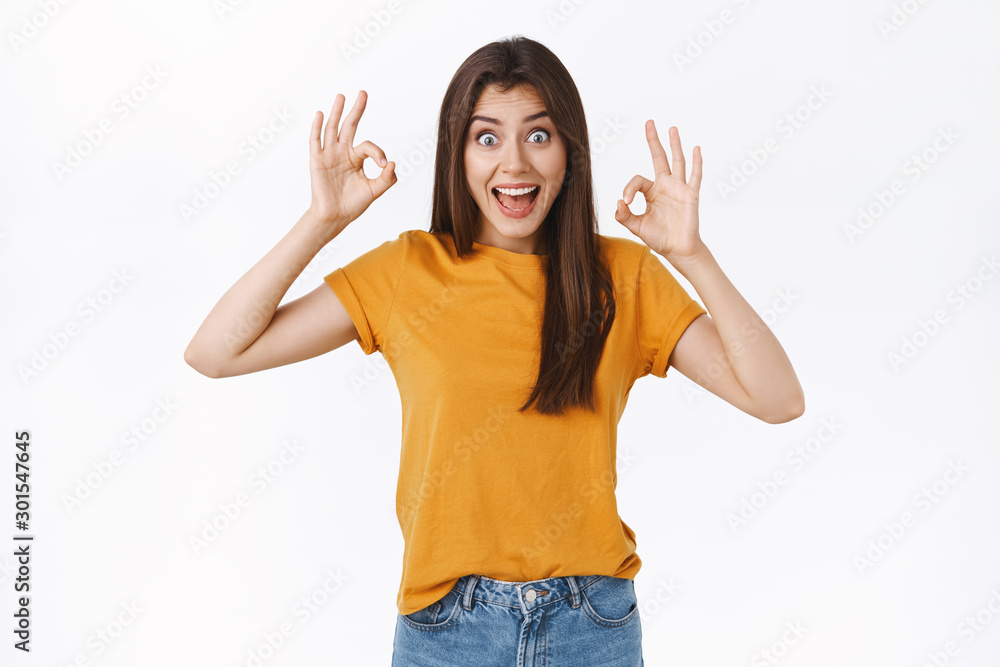 Excited, funny cheerful woman look wild and amused, widen eyes thrilled showing okay, ok gesture with amazement, impressed with excellent band performance, recommend event everyone, white background Excited, funny cheerful woman look wild and amused, widen eyes thrilled showing okay, ok gesture with amazement, impressed with excellent band performance, recommend event everyone, white background