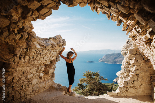 View from Monolithos, landscape at the island Rhodes, Greece. Girl admires the beauty of the landscape