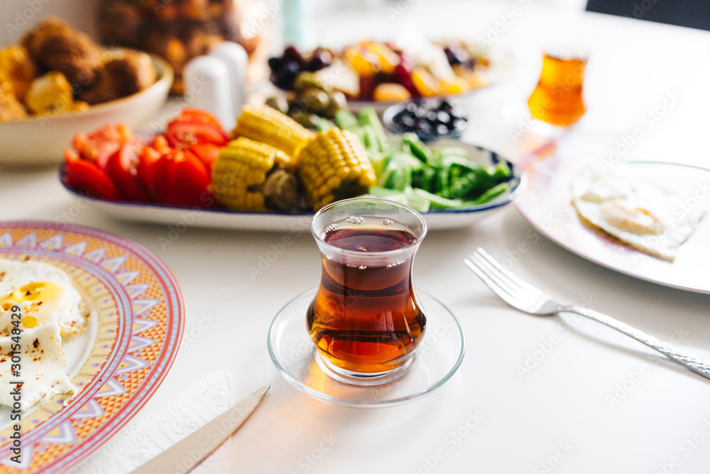 Traditional a glass of Turkish Tea and breakfast Traditional a glass of Turkish Tea and breakfast