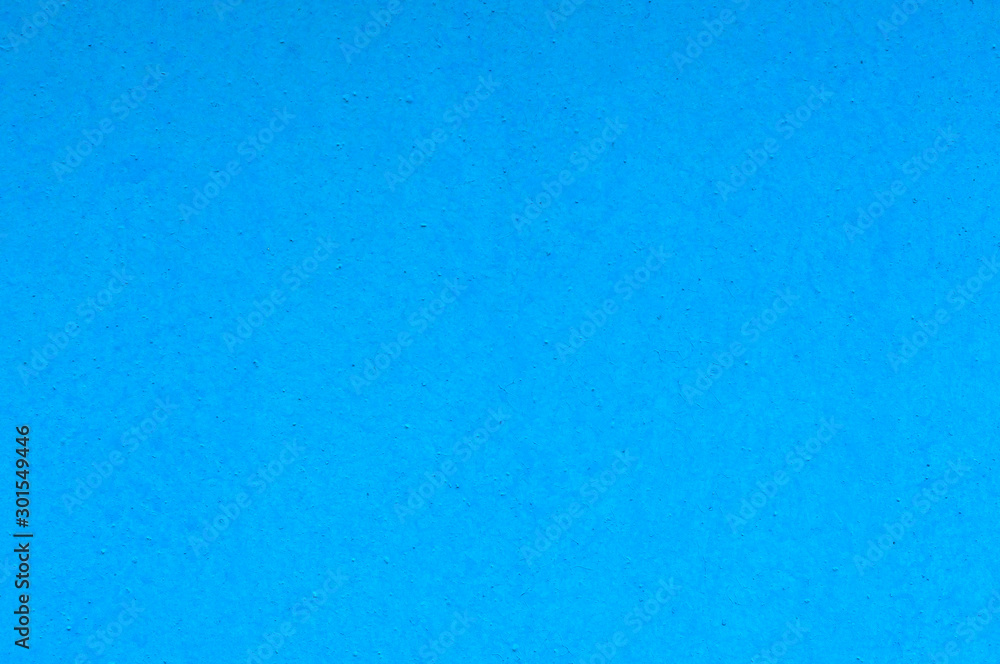 Plain bright blue, blue simple background. Part of the stone concrete surface of the wall painted blue juicy color. Plain bright blue, blue simple background. Part of the stone concrete surface of the wall painted blue juicy color.
