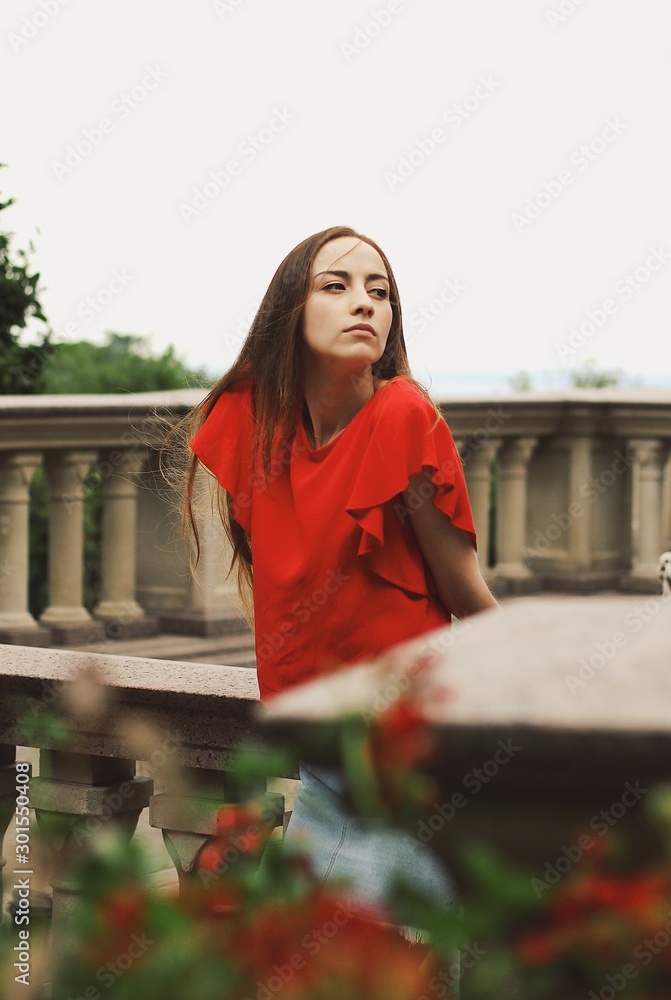 Young pretty girl's portrait on parkland background