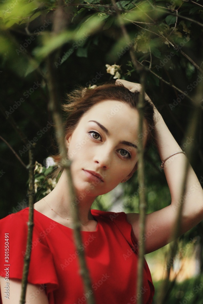 Young pretty girl's portrait on parkland background