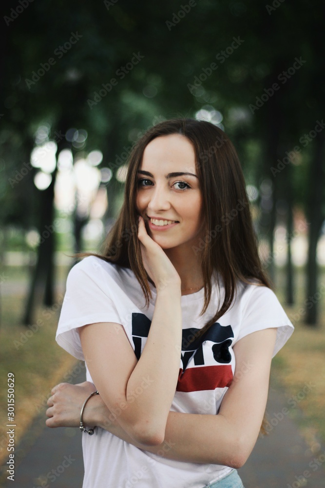 Young pretty girl walking down the street