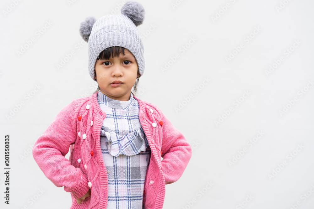 Adorable asian little girl is crying with unpleasant situation on the light gray background. Adorable asian little girl is crying with unpleasant situation on the light gray background.