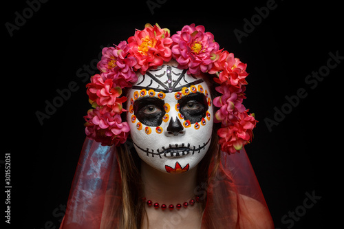 Portrait of a young girl with halloween makeup. Sugar skull makeup. Calavera Catrina. Dia de los muertos. Day of the Dead.