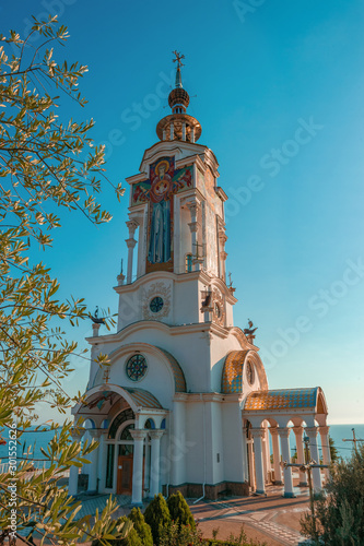 Temple lighthouse in honor of St. Nicholas on the seashore. Monument to the dead on the waters photo