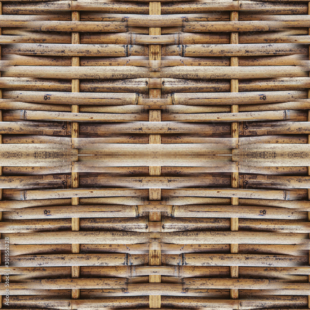 Fence made of woven dry bamboo in the Park. Natural braided background Fence made of woven dry bamboo in the Park. Natural braided background