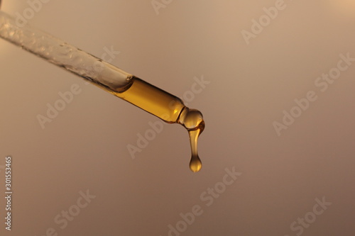 Принти на полотні Closeup of a piepette with organic rosehip oil on a white background