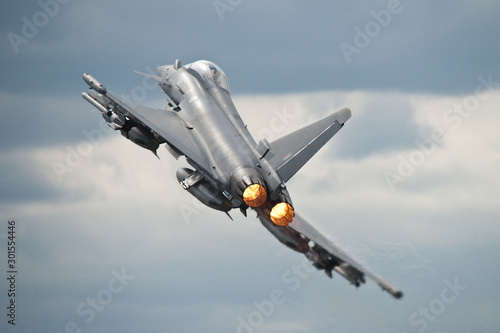 Wallpaper Mural An RAF Typhoon takes off fully loaded with weapons on its wings to perform a dis