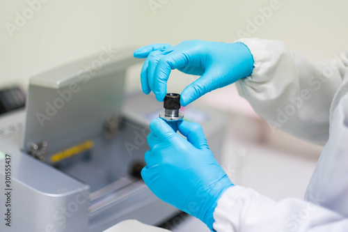 Analyst is prepare the sample solution for test of specific rotation by automatic polarimeter in the laboratory, concept of chemical laboratory in pharmaceutical industry, selective focus photograph.