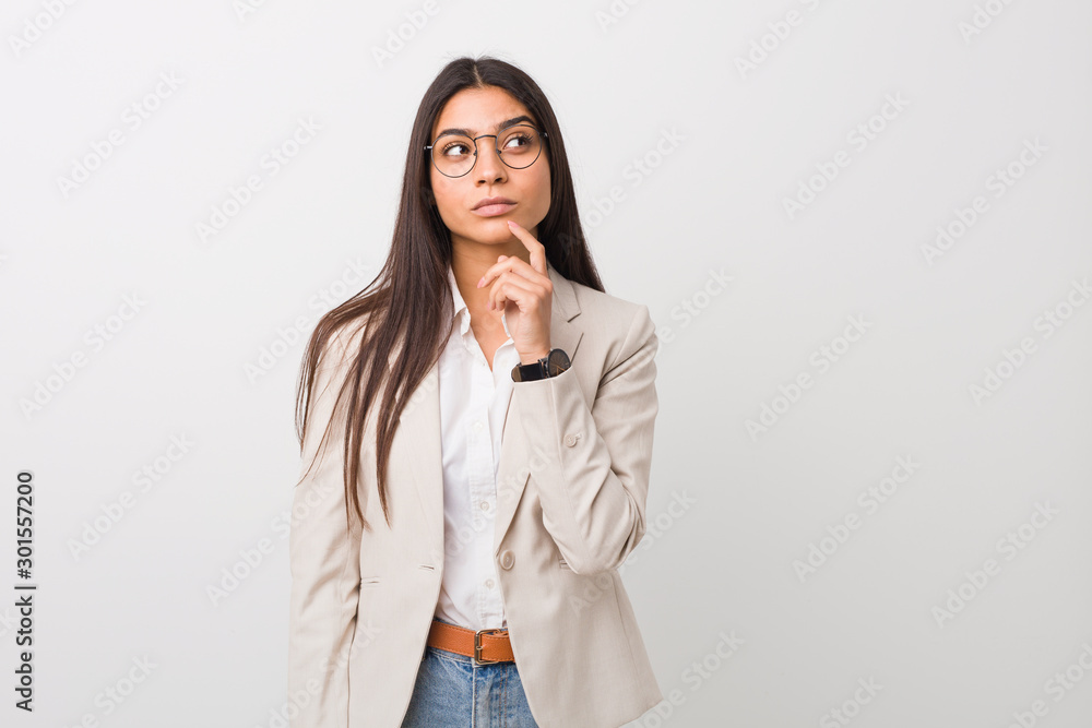 Young business arab woman isolated against a white background looking sideways with doubtful and skeptical expression. Young business arab woman isolated against a white background looking sideways with doubtful and skeptical expression.
