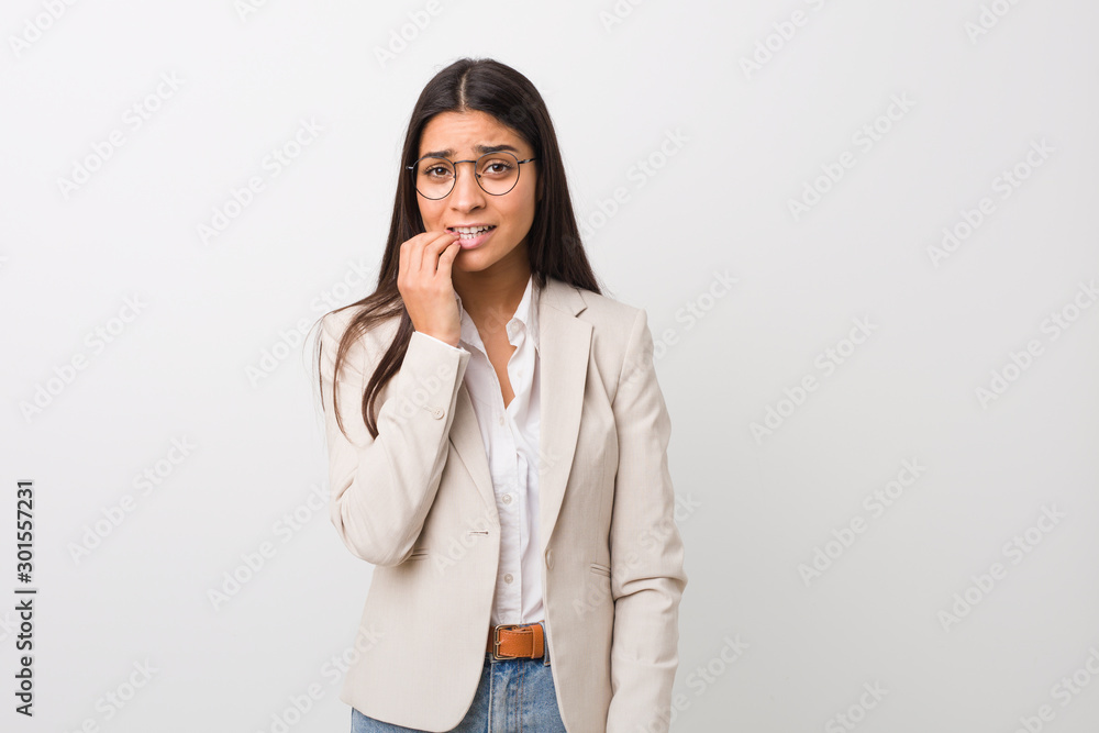 Young business arab woman isolated against a white background biting fingernails, nervous and very anxious. Young business arab woman isolated against a white background biting fingernails, nervous and very anxious.