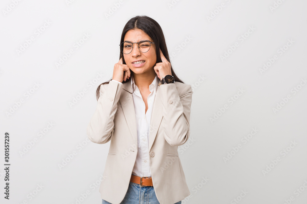 Young business arab woman isolated against a white background covering ears with hands. Young business arab woman isolated against a white background covering ears with hands.