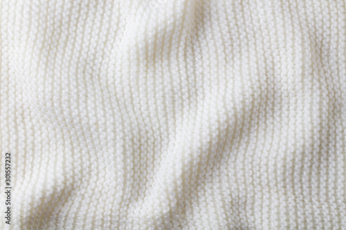 Knitted white scarf pattern background. Copy space. Top view.