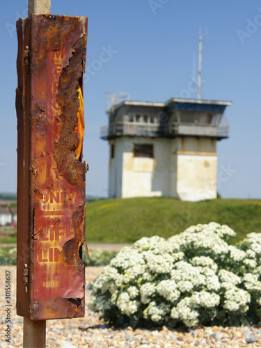 A rusted life line for rescuing people in the sea sits in front of the old and abandoned coastguard look out tower at the mouth of Shoreham Harbour in West Sussex.