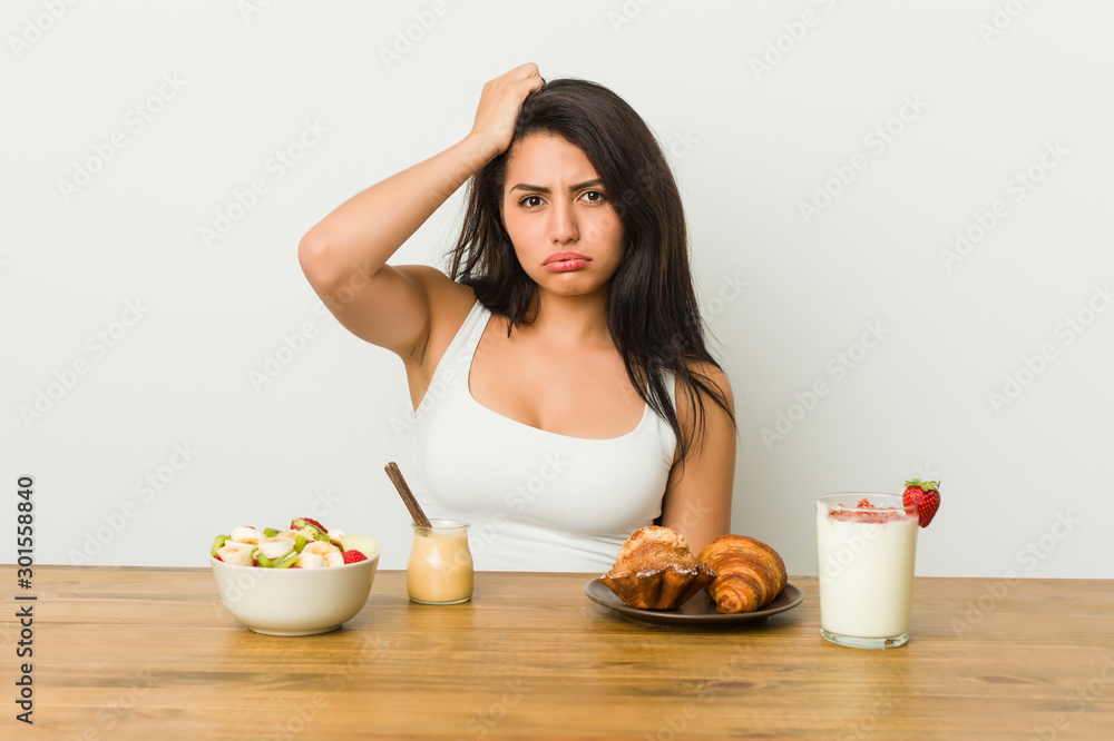 Young curvy woman taking a breakfast tired and very sleepy keeping hand on head. Young curvy woman taking a breakfast tired and very sleepy keeping hand on head.