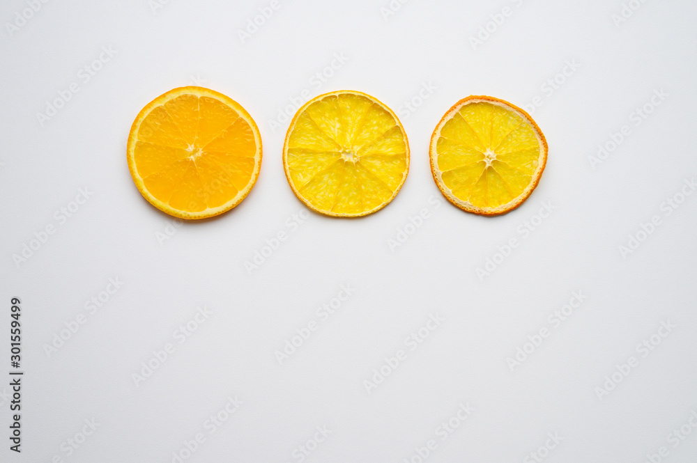 fruit pattern of three orange slices in fresh, dried and dry form on a white background. concept of withering and aging fruit pattern of three orange slices in fresh, dried and dry form on a white background. concept of withering and aging