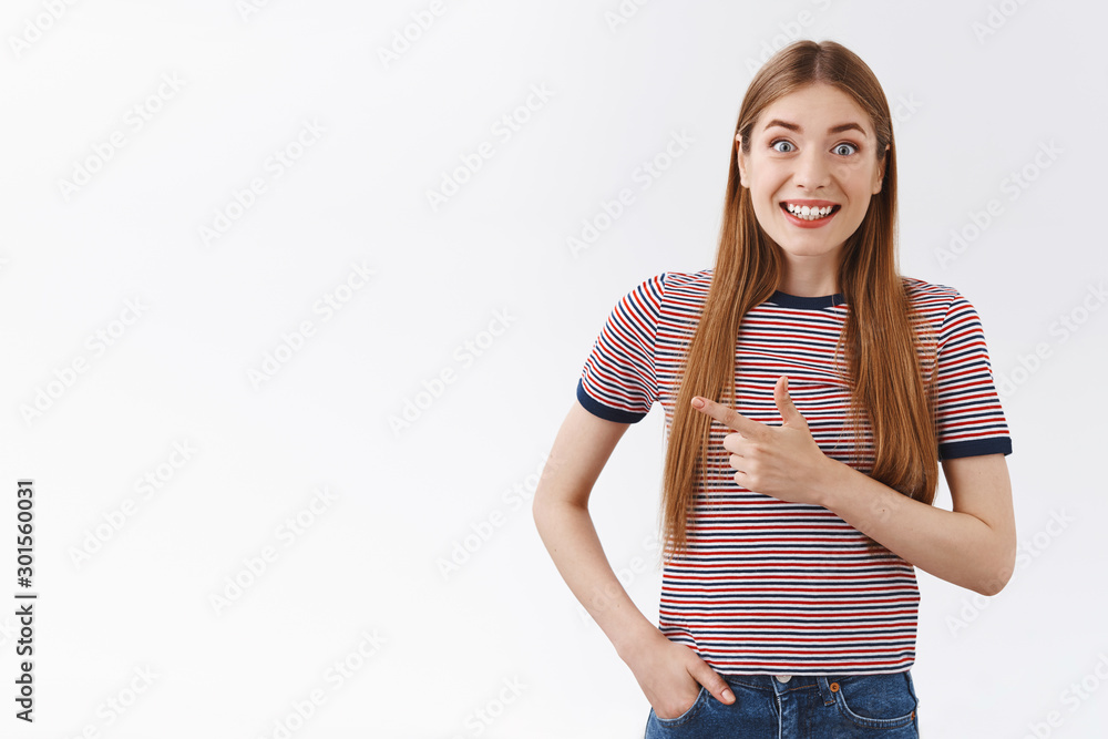 Excited, cheerful and happy young caucasian woman with long hair, wear striped t-shirt, smiling astonished and upbeat, pointing left white copyspace, very enthusiastic discuss awesome chance Excited, cheerful and happy young caucasian woman with long hair, wear striped t-shirt, smiling astonished and upbeat, pointing left white copyspace, very enthusiastic discuss awesome chance