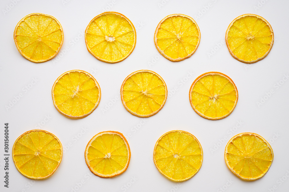 fruit pattern of a row of dried orange slices on a white background