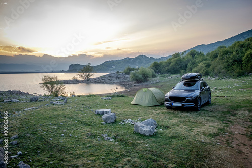 Adventures Camping tourism and tent and car next to the lake. Landscape outdoor in morning, Serbia.