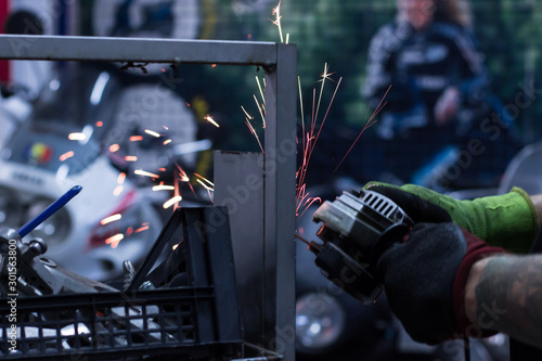 Worker cutting metal in the garage