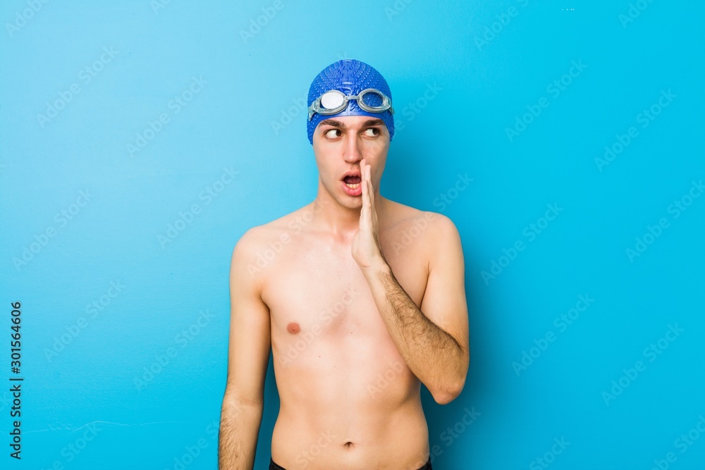 Young swimmer man is saying a secret hot braking news and looking aside