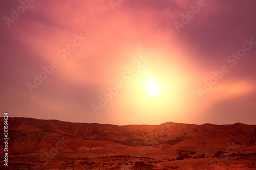 Mountain nature landscape. Desert in the evening. Orange sunset in mountains. View of mountains ridge against a sunset sky. Nature background
