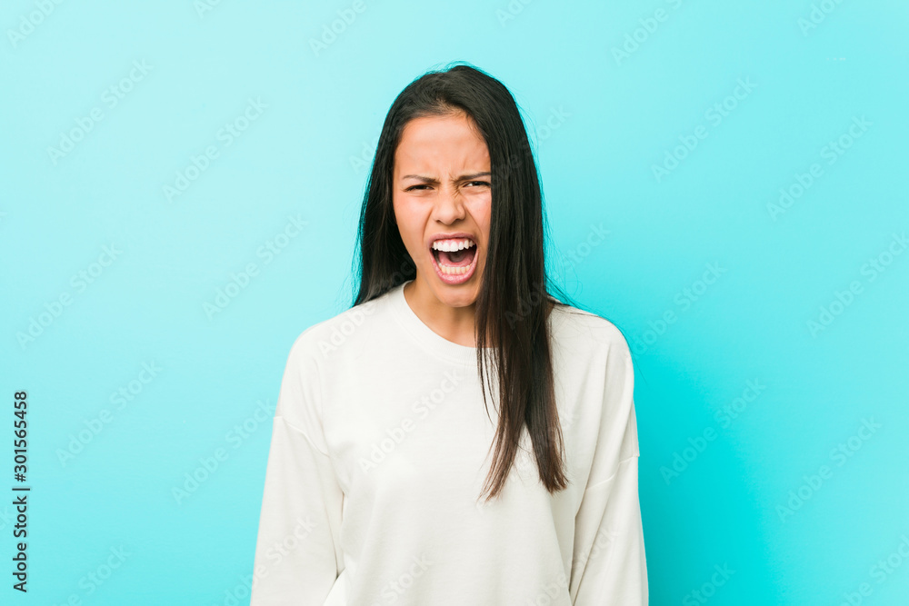 Young pretty hispanic woman screaming very angry and aggressive. Young pretty hispanic woman screaming very angry and aggressive.