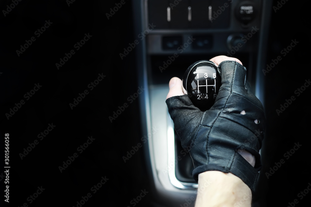 Gear lever. Manual Transmission. Hand on the gear shift in a car. Stock