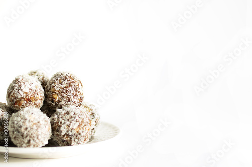 Energy balls on a white bowl on a white background