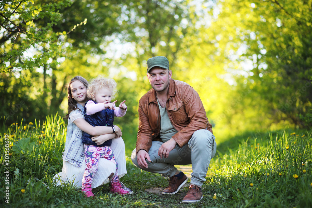 Fototapeta premium Girl with father in the park in the spring