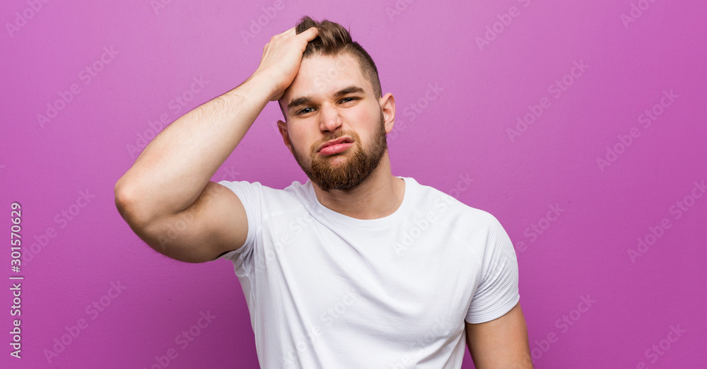 Young handsome caucasian man tired and very sleepy keeping hand on his head. Young handsome caucasian man tired and very sleepy keeping hand on his head.