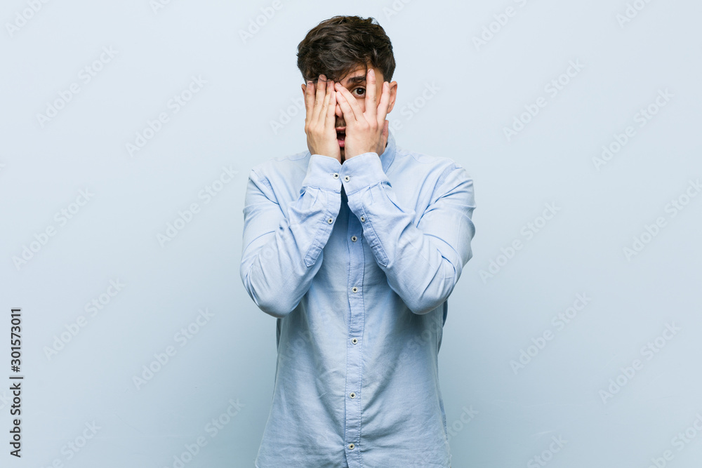 Young hispanic business man blink through fingers frightened and nervous. Young hispanic business man blink through fingers frightened and nervous.