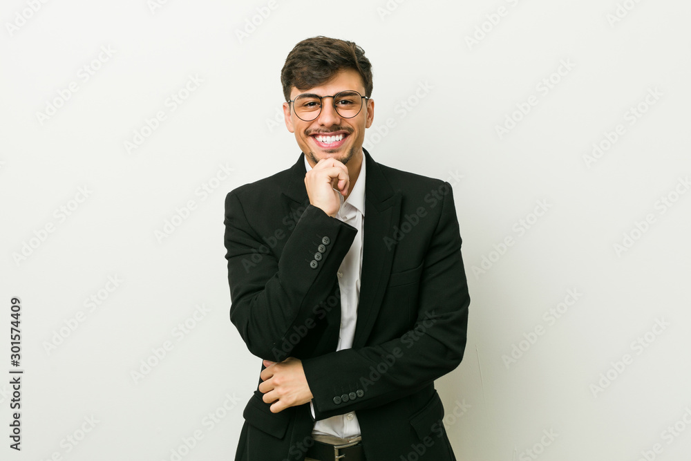 Young business hispanic man smiling happy and confident, touching chin with hand. Young business hispanic man smiling happy and confident, touching chin with hand.
