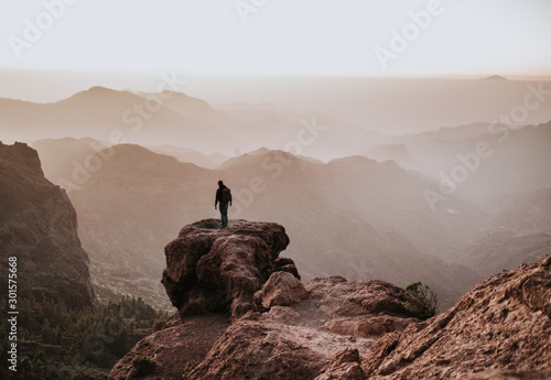 person reflecting on top of the mountain