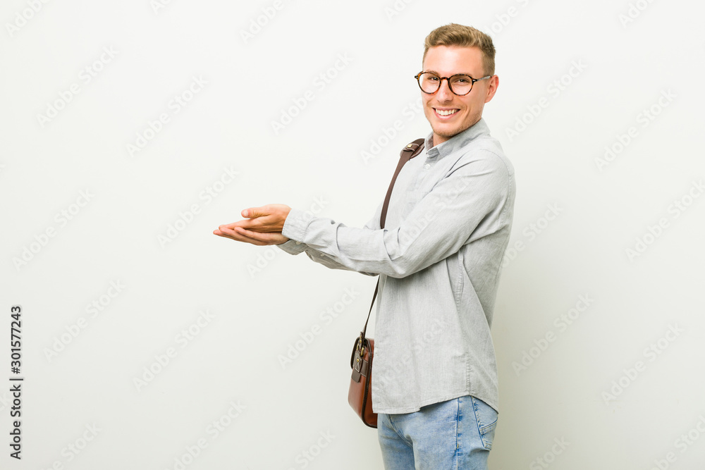 Young caucasian business man holding a copy space on a palm. Young caucasian business man holding a copy space on a palm.