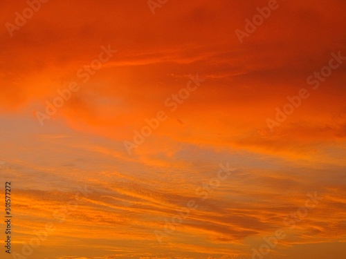 Fototapeta Naklejka Na Ścianę i Meble -  An orange evening sky with clouds