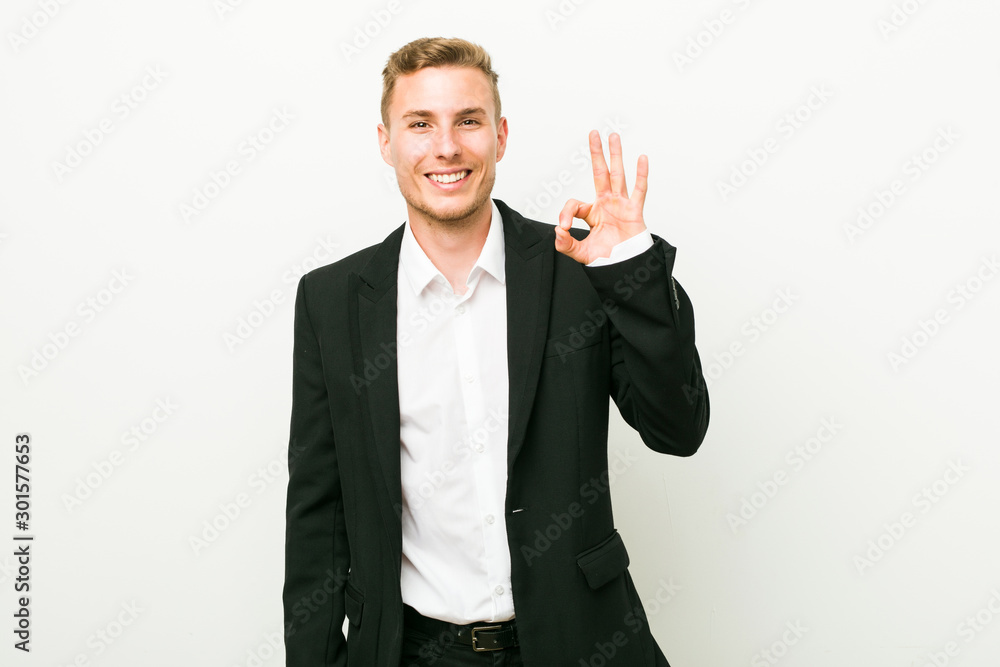 Young caucasian business man cheerful and confident showing ok gesture. Young caucasian business man cheerful and confident showing ok gesture.