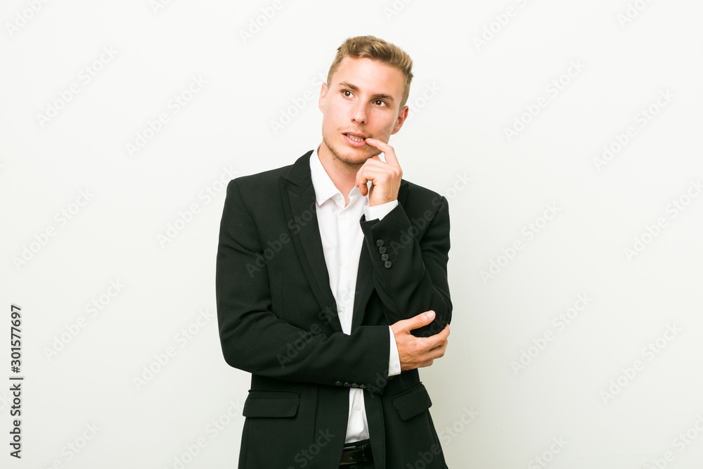 Young caucasian business man relaxed thinking about something looking at a copy space. Young caucasian business man relaxed thinking about something looking at a copy space.