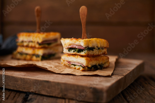 Baked spinach and ham sandwich with sauce. photo