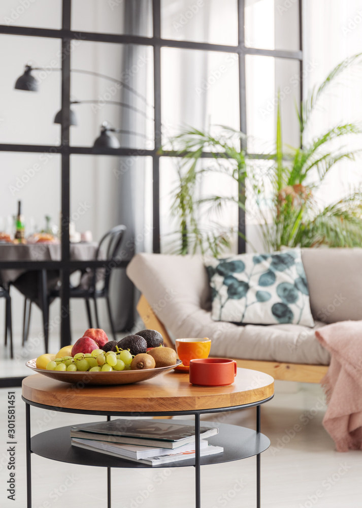 Coffee and fruits on small wooden coffee table in elegant dining and living room interior Coffee and fruits on small wooden coffee table in elegant dining and living room interior