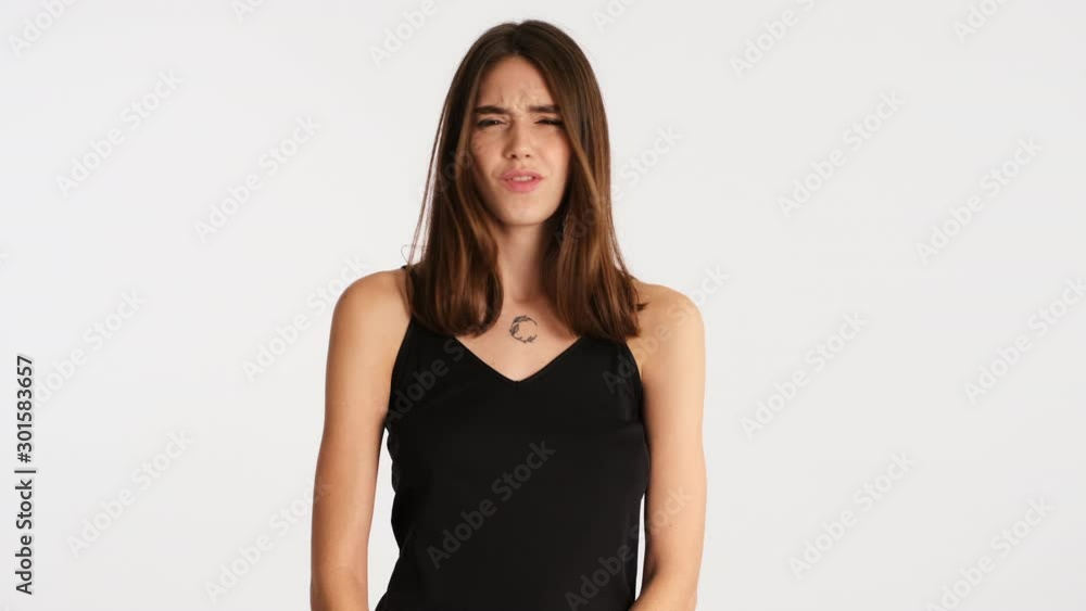 Young pensive woman thinking and emotionally showing no gesture with crossed hands over white background Young pensive woman thinking and emotionally showing no gesture with crossed hands over white background