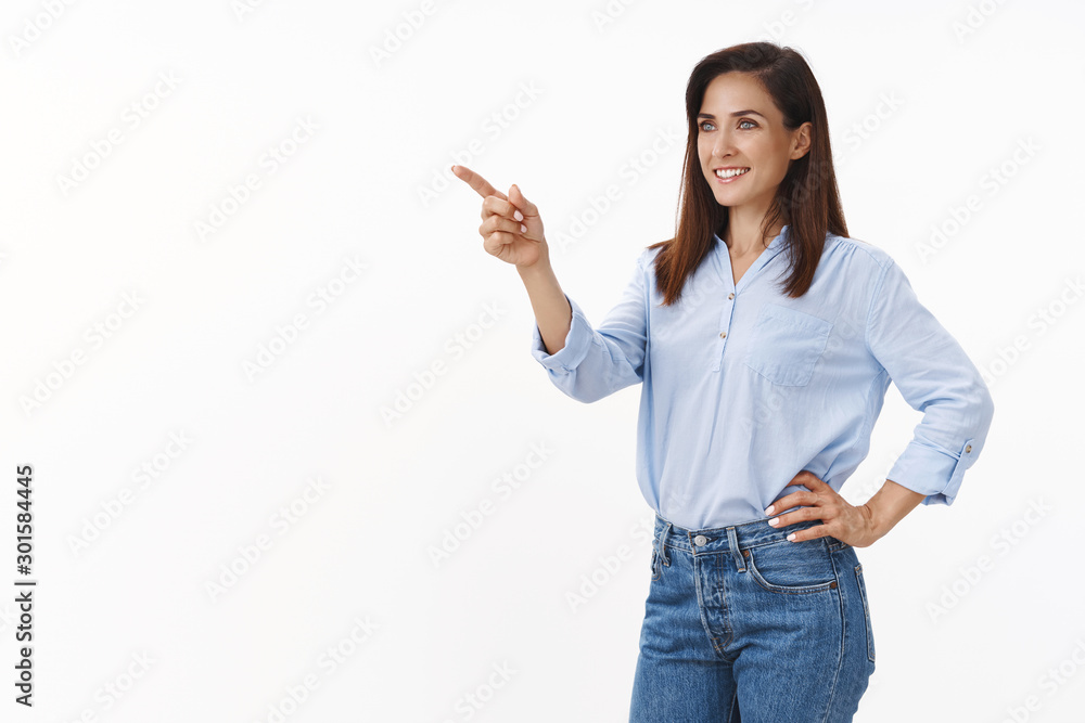 Determined businesswoman feel motivated win deal, achieve success, stand half-turned pointing looking pleased left copyspace, see good deal, business concept, stand confident white background Determined businesswoman feel motivated win deal, achieve success, stand half-turned pointing looking pleased left copyspace, see good deal, business concept, stand confident white background