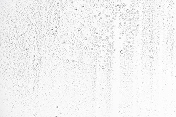 white isolated background water drops on the glass / wet window glass with splashes and drops of water and lime, texture autumn background