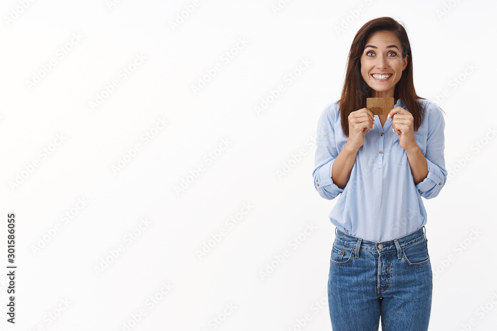 Excited middle-aged woman shopping, smiling broadly thrilled awesome sale week, give credit card make purchase, pay for product, grinning amazed, receive big cashback, stand white background Excited middle-aged woman shopping, smiling broadly thrilled awesome sale week, give credit card make purchase, pay for product, grinning amazed, receive big cashback, stand white background