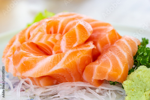 Salmon slice arranged beautiful with wasabi and vegetable ,close up