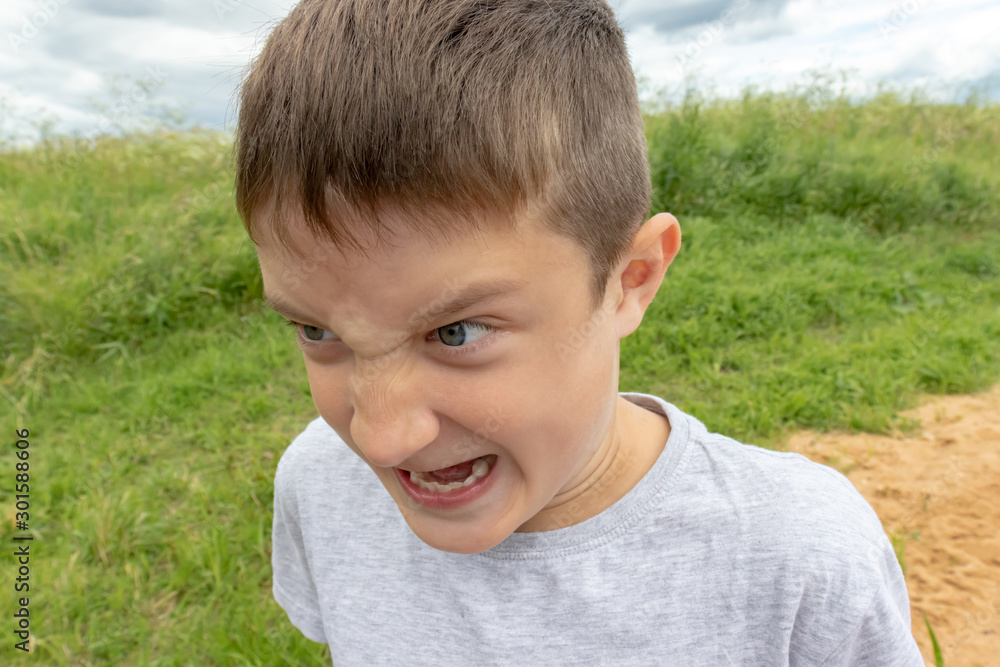 A shouting, screaming boy with wide open mouth, facial expression of a teen boy A shouting, screaming boy with wide open mouth, facial expression of a teen boy